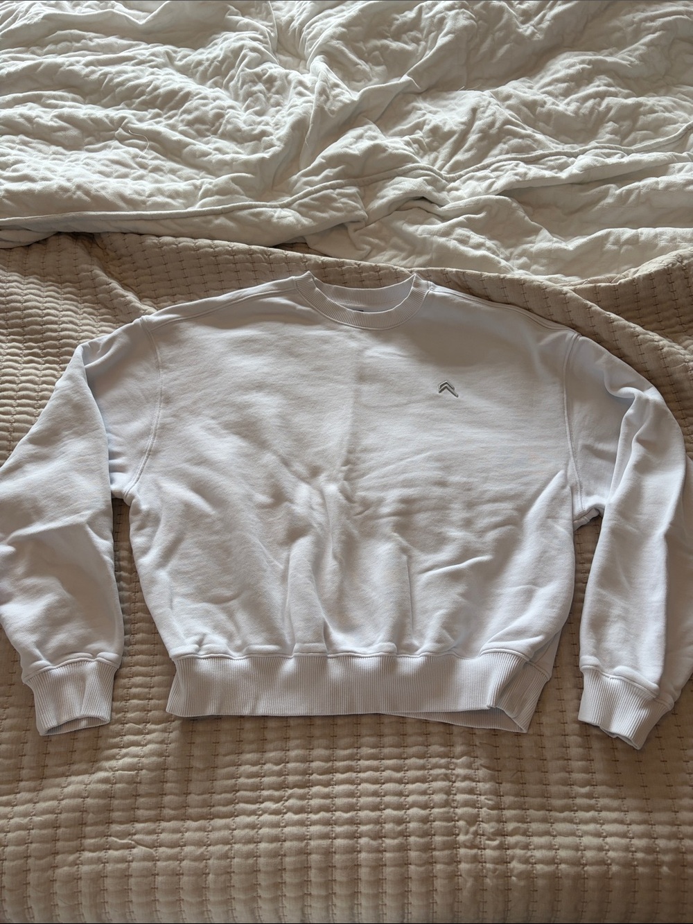 Minimal White Crewneck Sweatshirt with Subtle Chevron Logo
